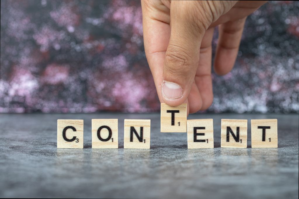GEO/AEO Xidməti 3 content-writing-with-black-letters-wooden-dices-blue-background-high-quality-photo